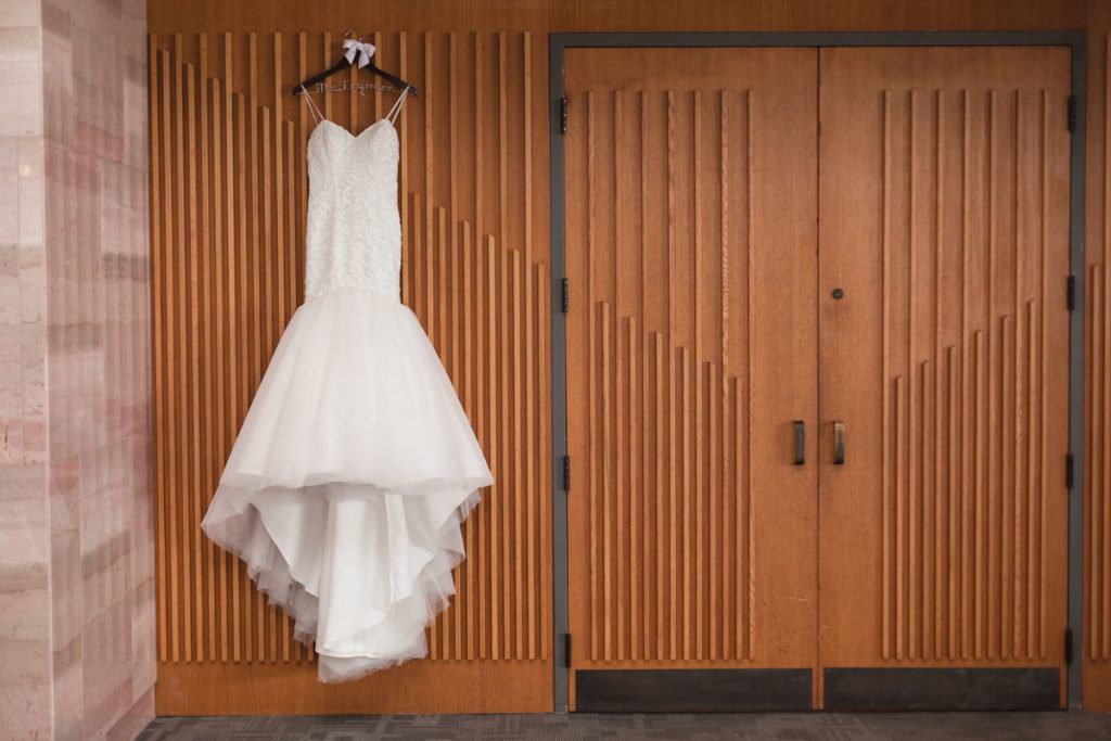 Wedding dress on hanger by top Orlando wedding photographer