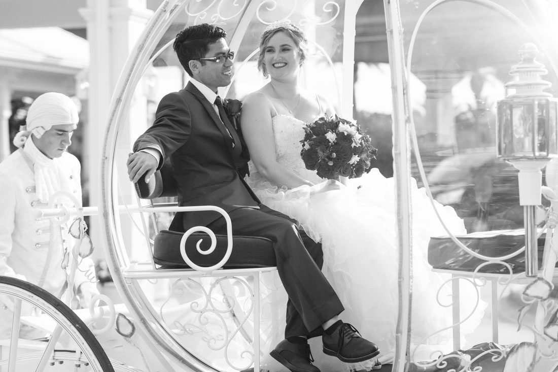 Romantic Disney wedding in Orlando featuring Cinderella's coach and a beauty and the best theme captured by top Orlando wedding photographer and videographer