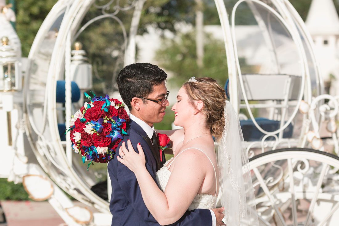 Romantic Disney wedding in Orlando featuring Cinderella's coach and a beauty and the best theme captured by top Orlando wedding photographer and videographer