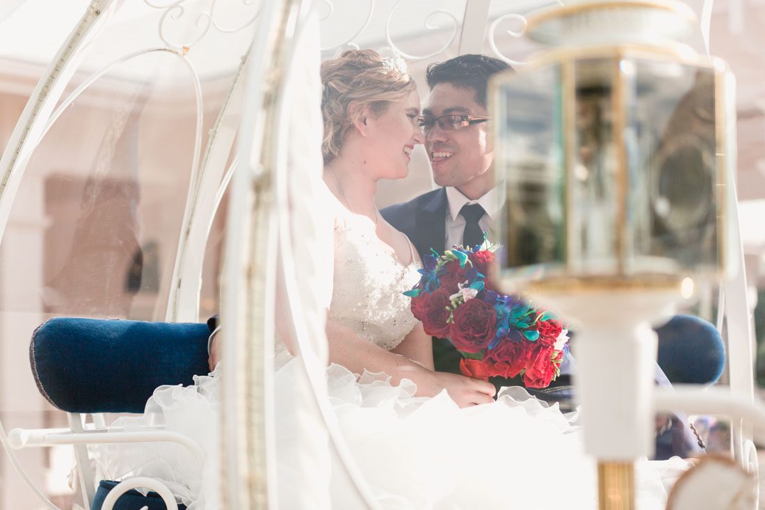 Romantic Disney wedding in Orlando featuring Cinderella's coach and a beauty and the best theme captured by top Orlando wedding photographer and videographer
