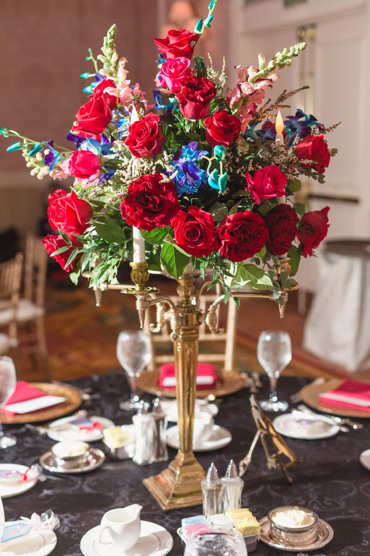 Romantic Disney wedding photography in Orlando featuring a red beauty and the best theme captured by top Orlando wedding photographer and videographer