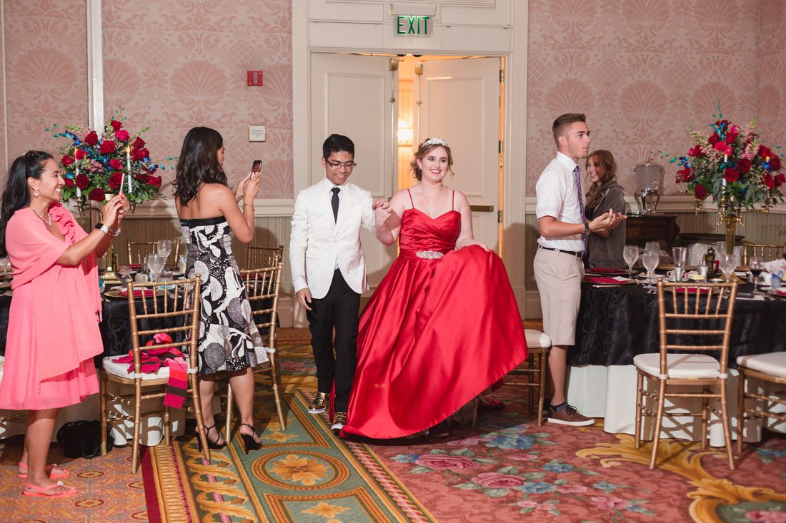 Romantic Disney wedding photography in Orlando featuring a red beauty and the best theme captured by top Orlando wedding photographer and videographer
