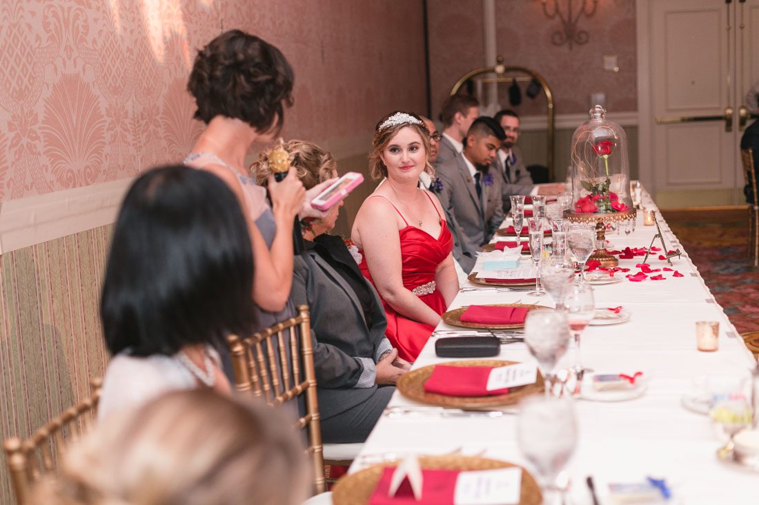 Romantic Disney wedding photography in Orlando featuring a red beauty and the best theme captured by top Orlando wedding photographer and videographer