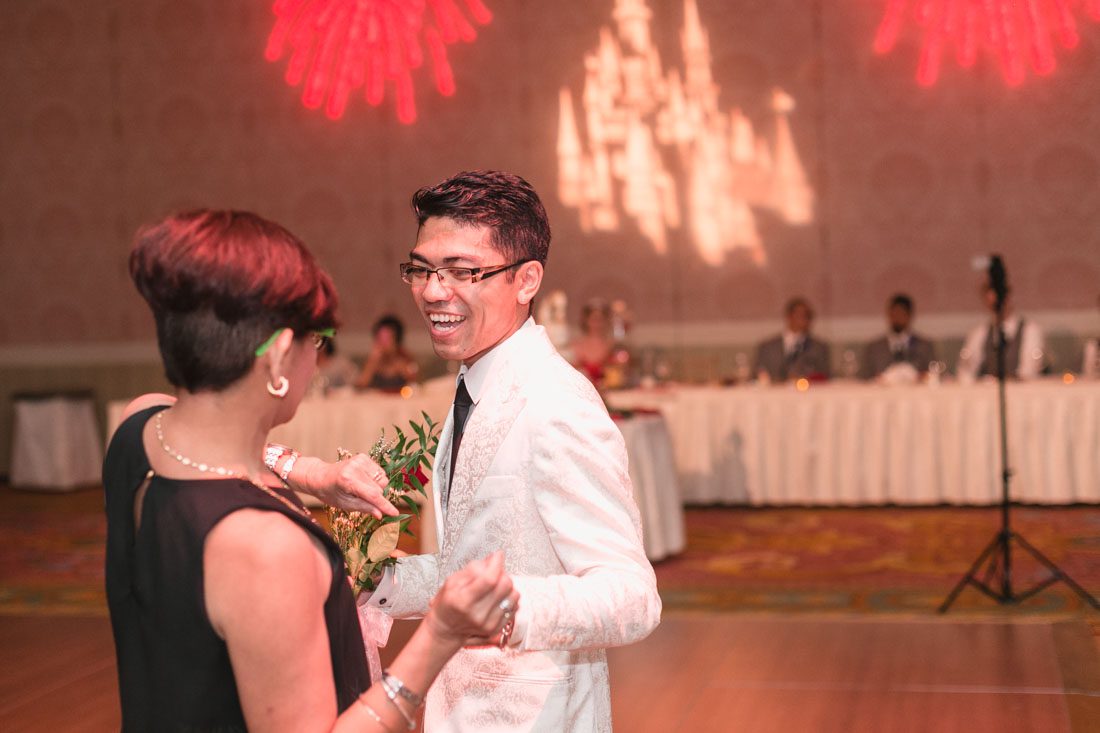 Romantic Disney wedding photography in Orlando featuring a red beauty and the best theme captured by top Orlando wedding photographer and videographer
