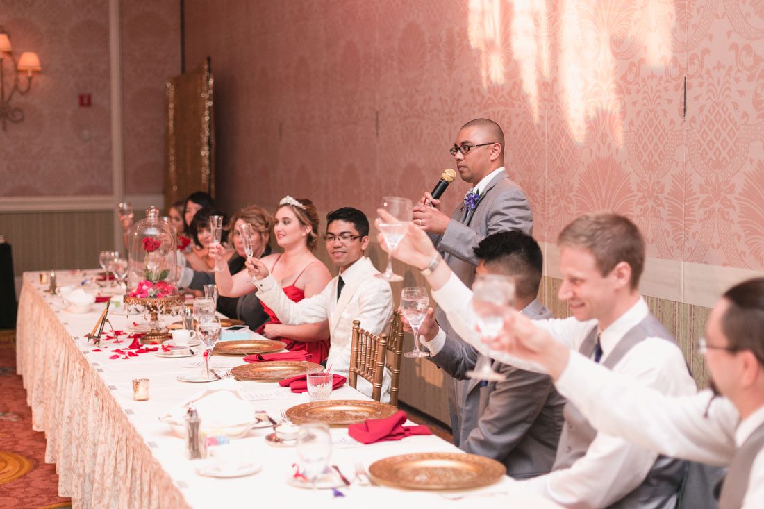 Romantic Disney wedding photography in Orlando featuring a red beauty and the best theme captured by top Orlando wedding photographer and videographer
