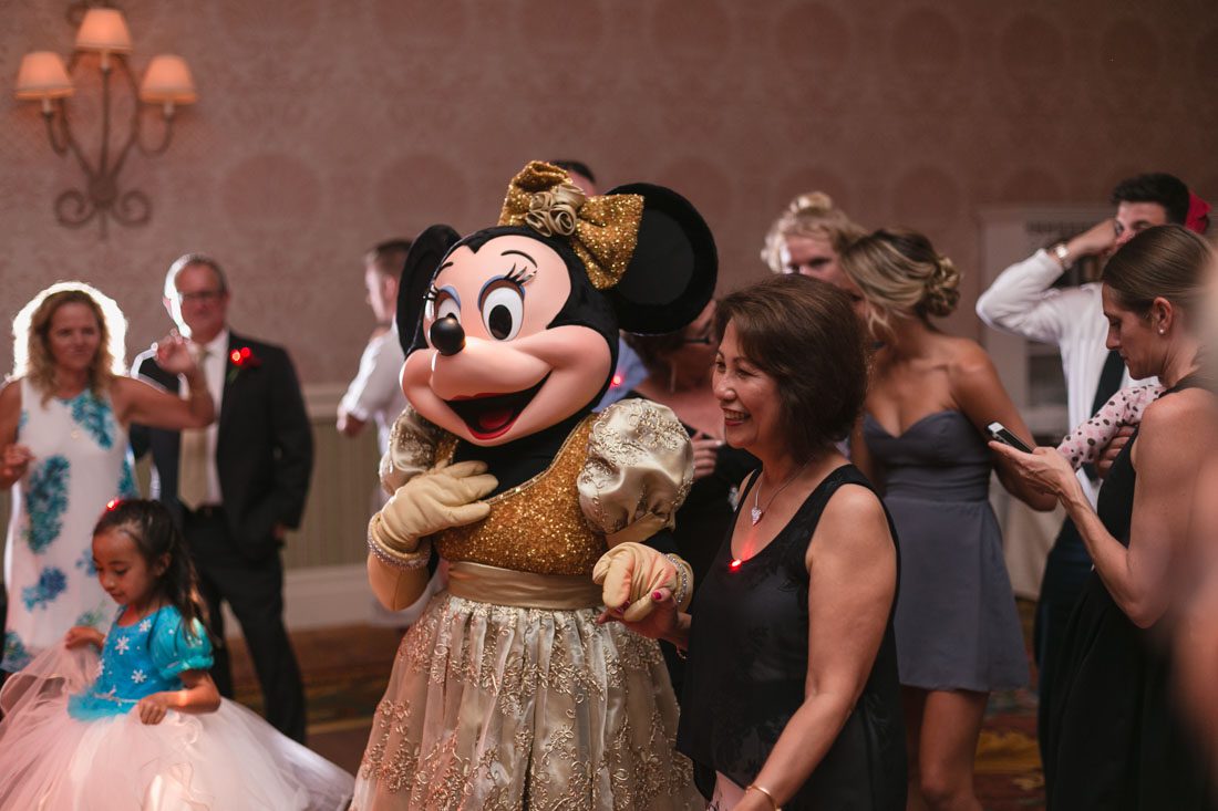 Romantic Disney wedding photography in Orlando featuring a red beauty and the best theme captured by top Orlando wedding photographer and videographer