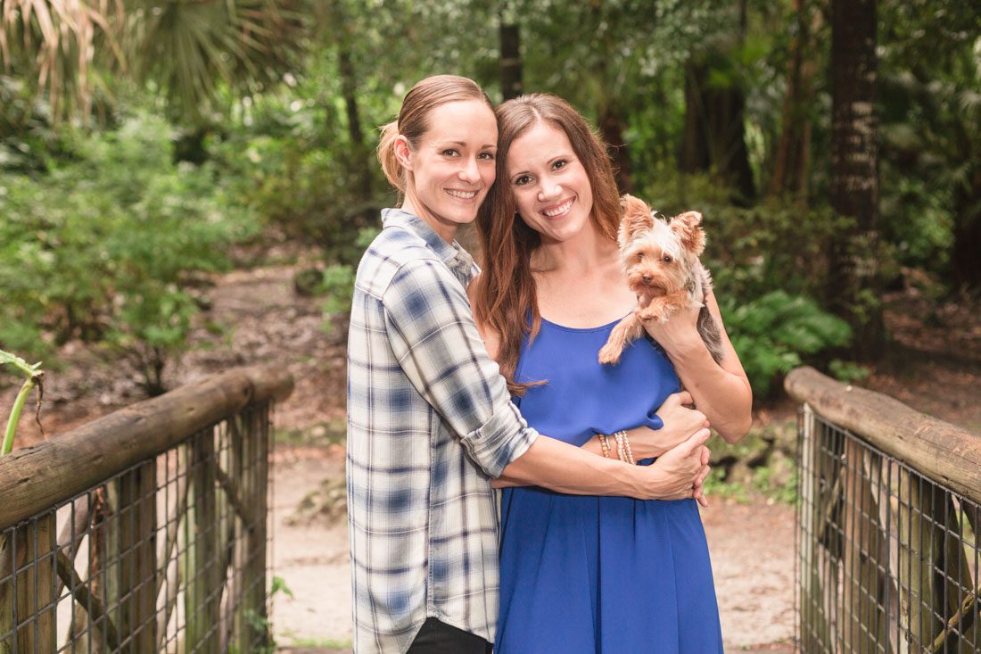 Romantic park LGBT engagement photography session with their adorable puppy dog by top Orlando wedding photographer