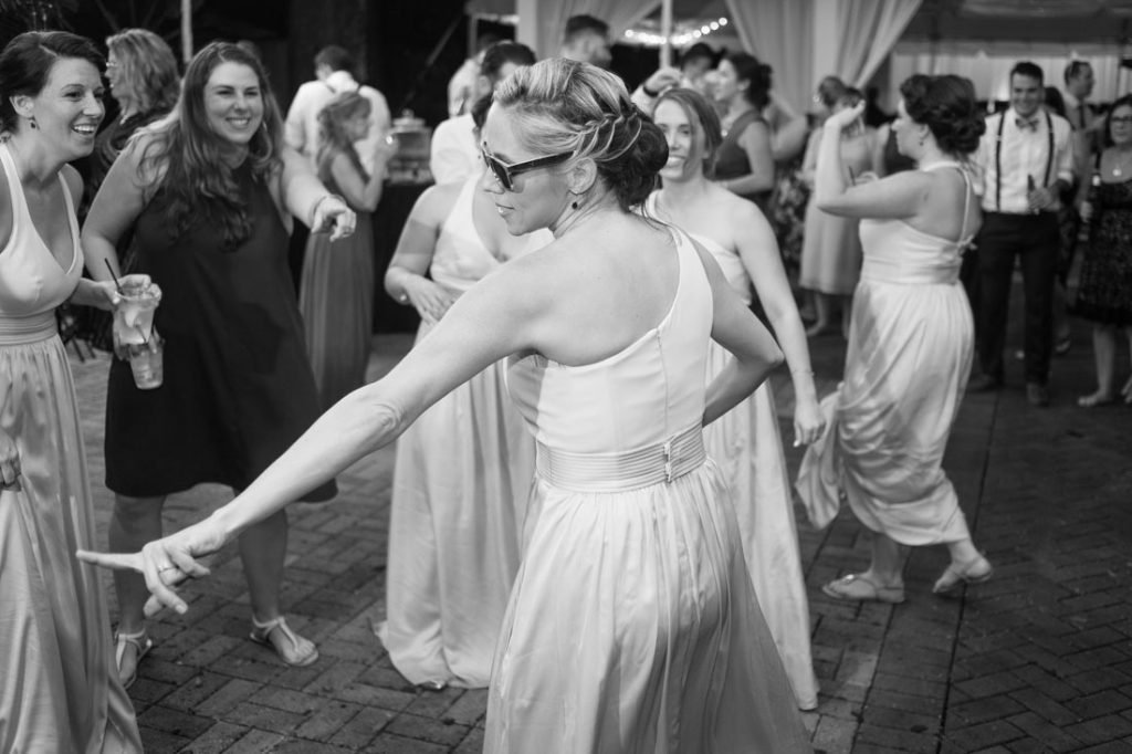 Orlando wedding photographer and videographer capture fun nighttime reception under a tent at the Veranda at Thornton Park