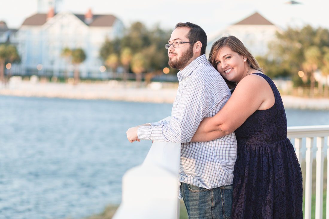 Orlando engagement photographer captures couple overlooking the water at Disney Boardwalk during their photo shoot
