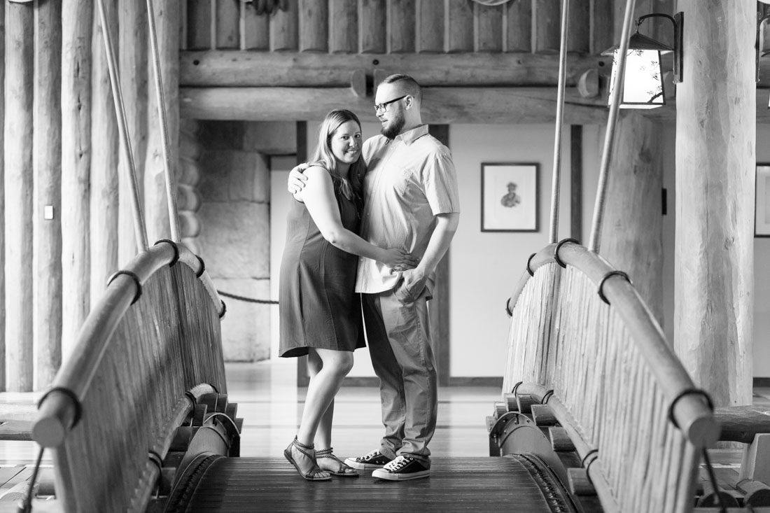 Couples pose at the bridge in the Wilderness Lodge for their engagement photos with Orlando photographer