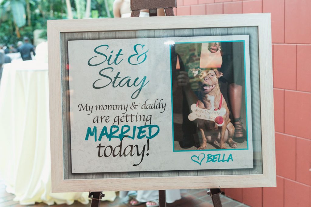Couple incorporates their dog into the wedding day with a unique sign at their ceremony entrance