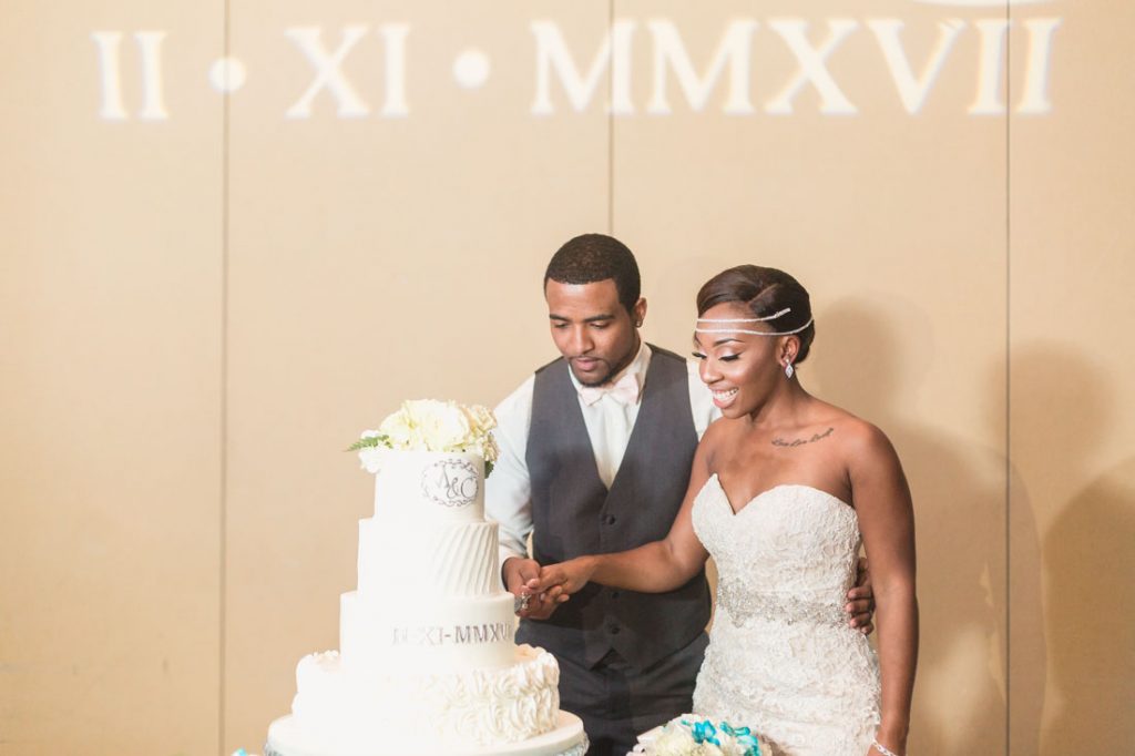 Bride and groom cut their wedding cake at their Orlando wedding