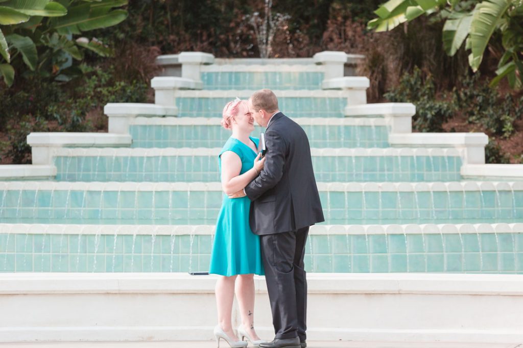 Romantic surprise proposal in front of a fountain at Disney captured by top Orlando wedding photographer