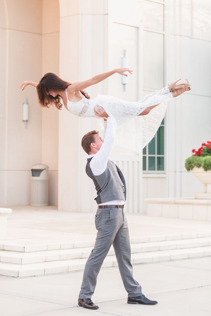Incredible unique engagement shot where the groom is lifting his bride overhead for a romantic dirty dancing inspired portrait in historic Winter Garden captured by Orlando photographer