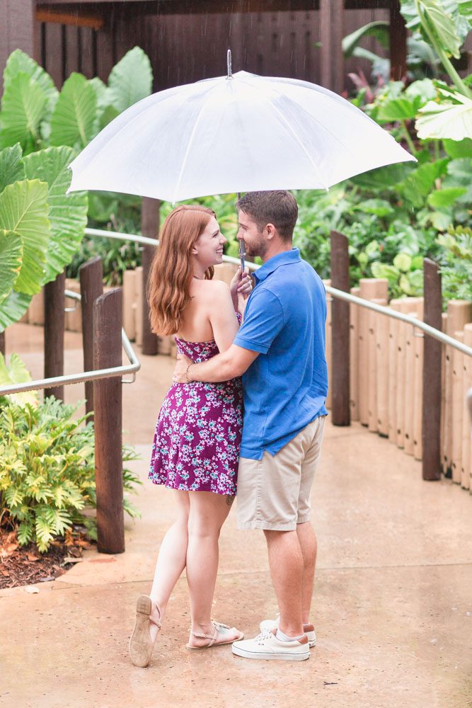 Sweet rainy day engagement photo shoot at Disney resort in Orlando, Florida