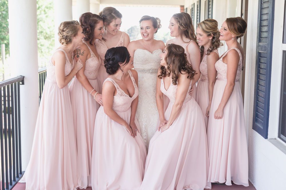 Bride getting ready with her bridesmaids featuring blush dresses for their country wedding day at a barn in Central Florida 