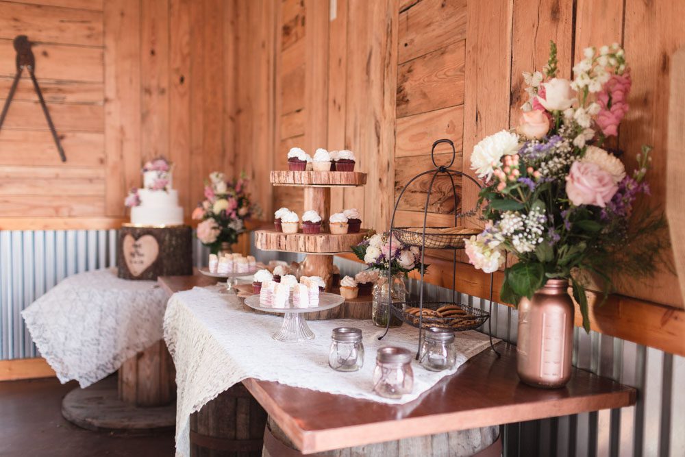 Dessert table with a lace runner at a country rustic wedding captured by top Orlando wedding photography team