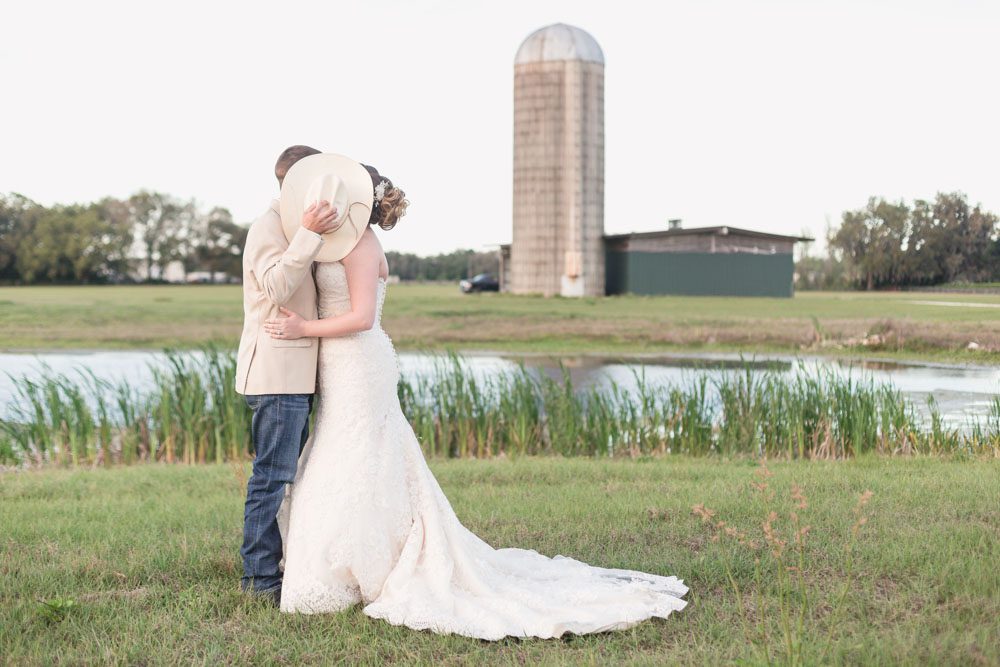 Sunset wedding photos at an outdoor country wedding in Sumterville, north of Orlando captured by top photographer in front of a silo