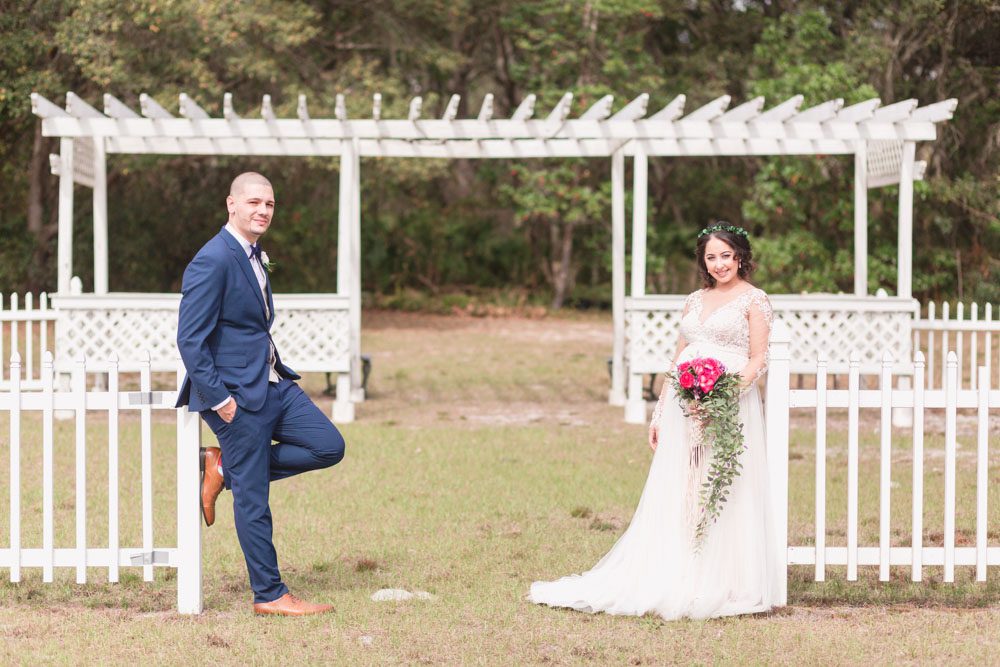 Sweet photo of the newlyweds on a dock during their romantic intimate backyard wedding day in Kissimmee Florida captured by top Orlando wedding photography team