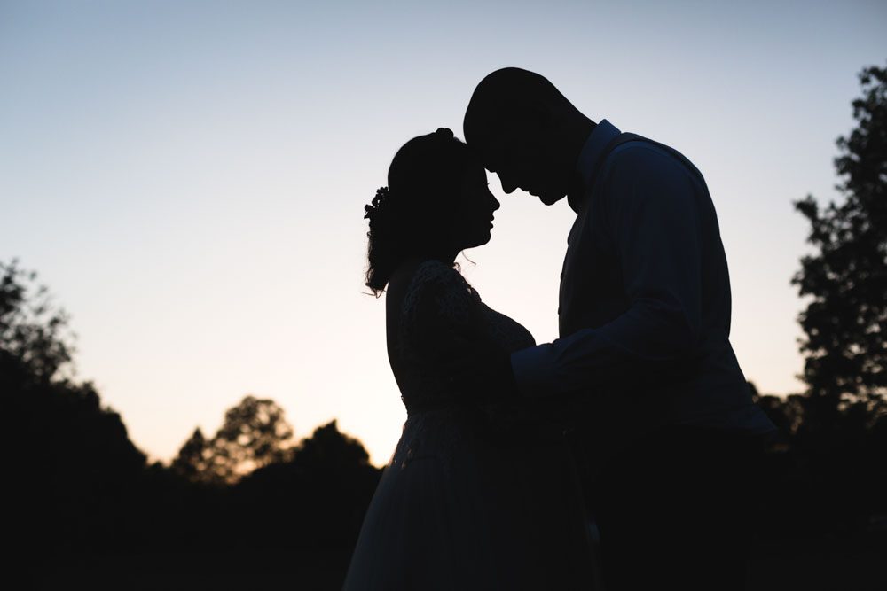 Silhouette photograph of the bride and groom on their wedding day captured by top Orlando wedding photographer