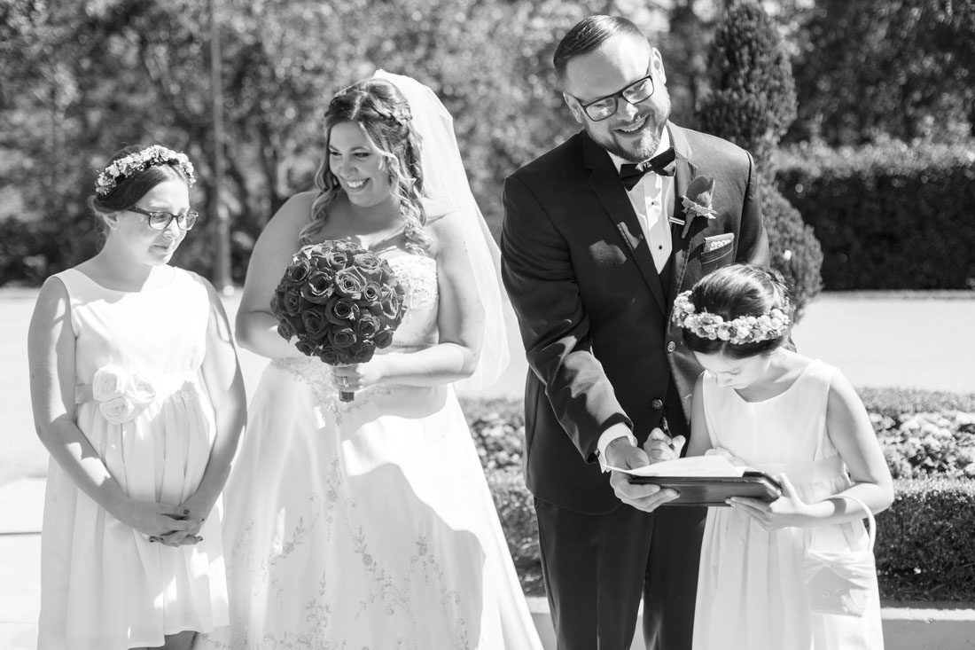 The couples children sign their marriage license during their Disney wedding in Orlando, Florida