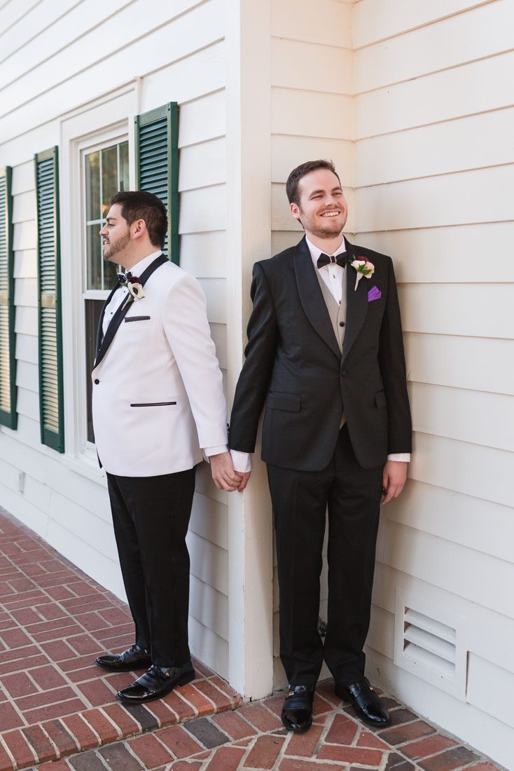 Gay wedding couples has a first touch at the Cypress Grove Estate House captured by top Orlando gay wedding photographers