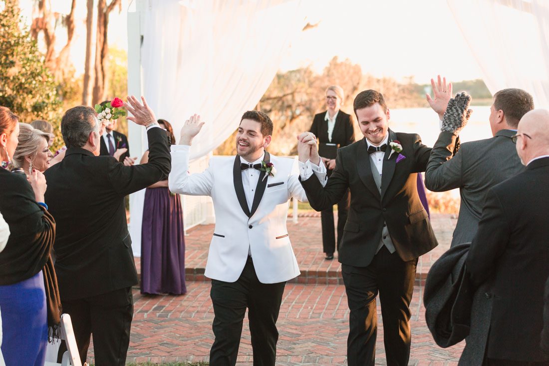 Orlando gay wedding ceremony outdoors on the waterfront at Cypress Grove captured by wedding photographers in Orlando