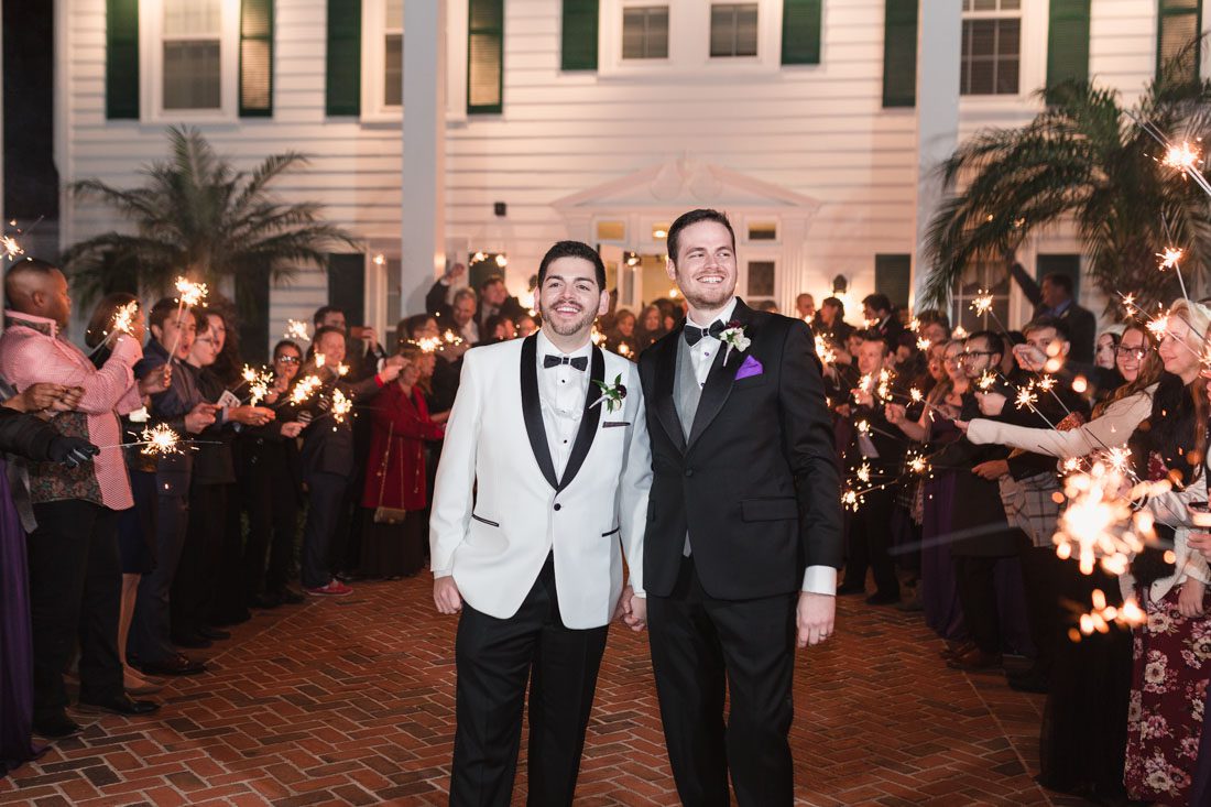 Grooms during their sparkler exit from their gay wedding at the Cypress Grove estate house by top same-sex wedding photographer in Orlando