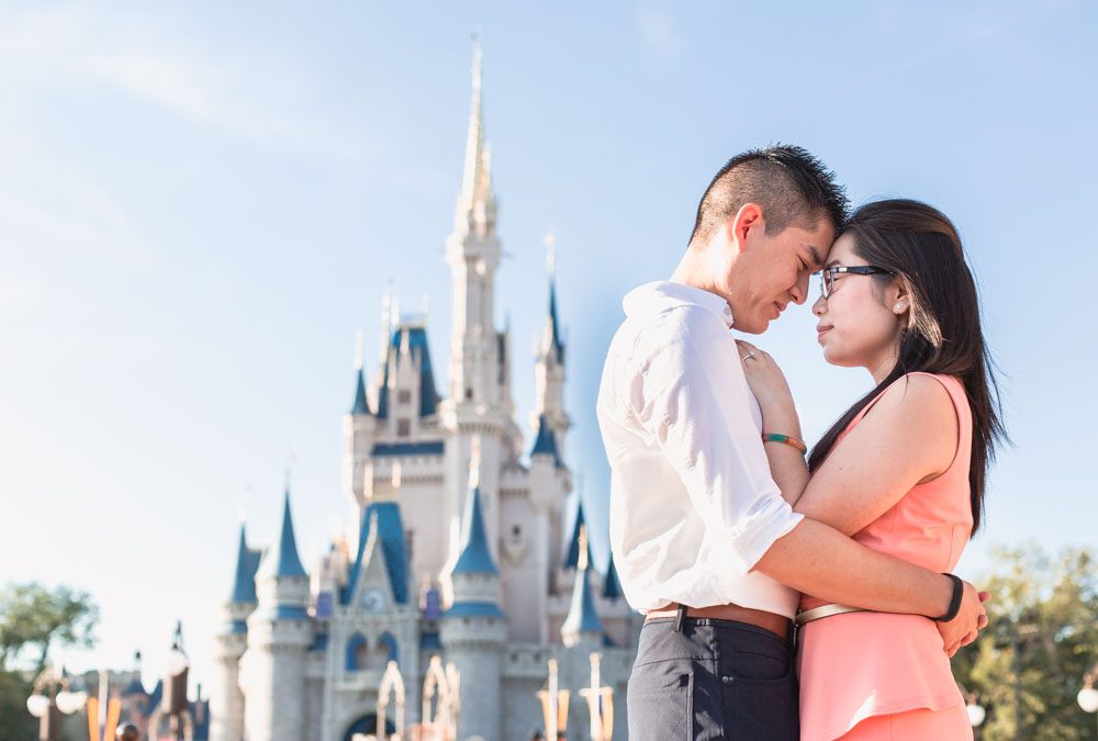 Engagement photo in front of the castle at Walt Disney World Magic Kingdom park in Orlando, Florida