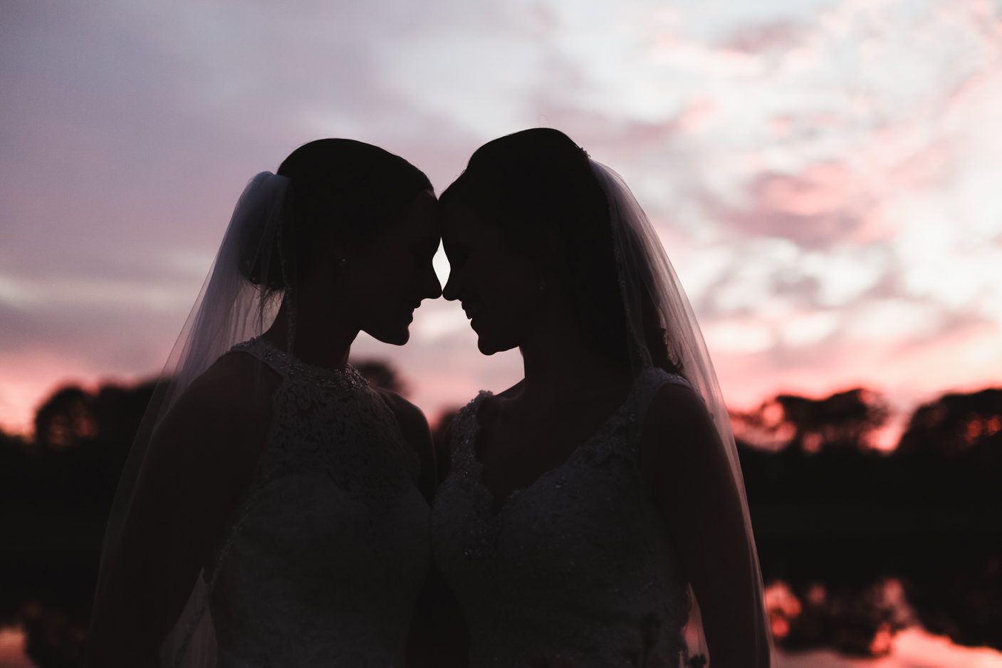 Silhouette of two brides during their gay wedding in Orlando captured by top photographer and videographer