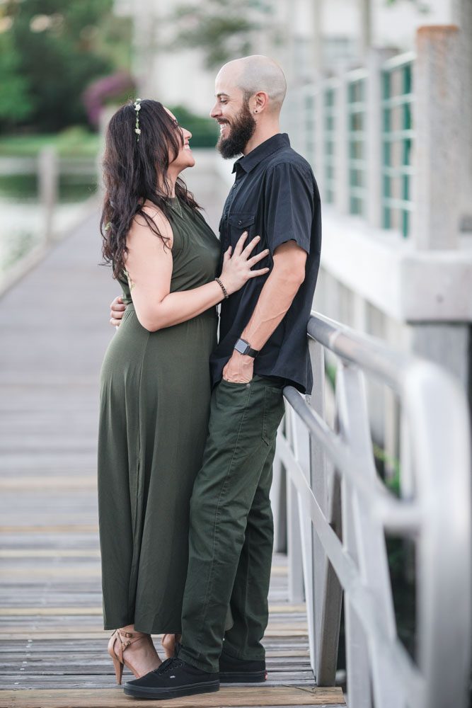 Romantic engagement session on the lakefront pier in Celebration captured by top Orlando wedding and engagement photographer
