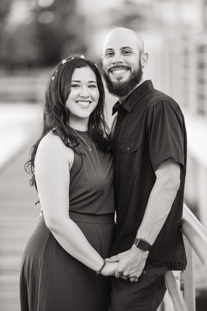 Black and white engagement session on the lakefront pier in Celebration captured by top Orlando wedding and engagement photographer