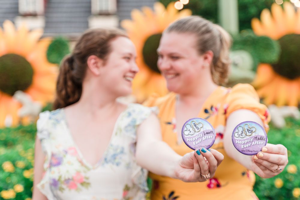 Romantic lesbian engagement session at Disney in Epcot during Flower and Garden Festival captured by top Orlando gay wedding photographer