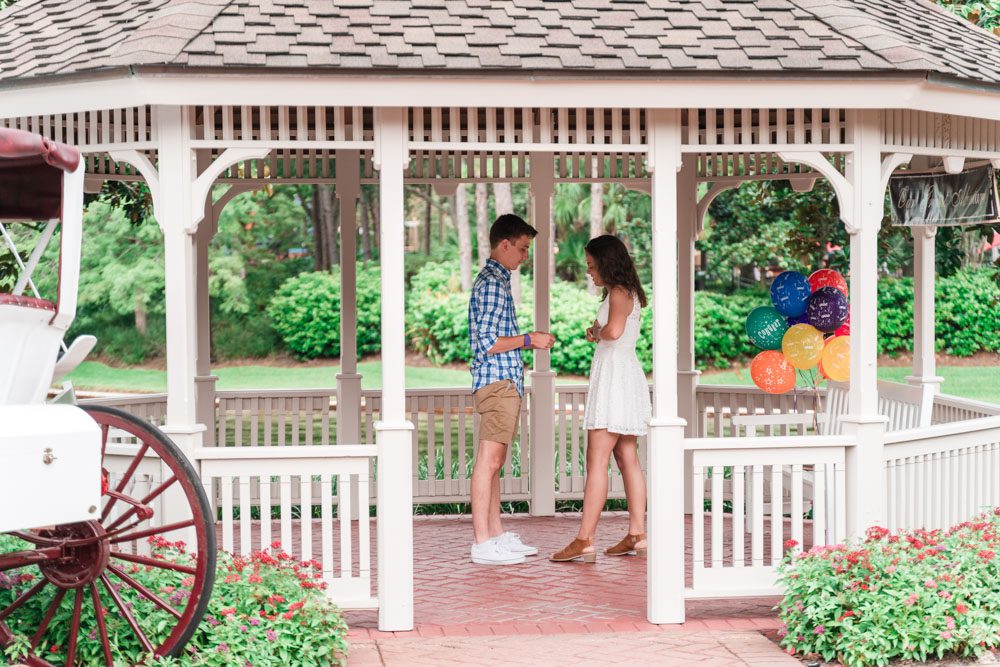 Surprise proposal photography at a gazebo at a Disney resort captured by top Orlando engagement photographer