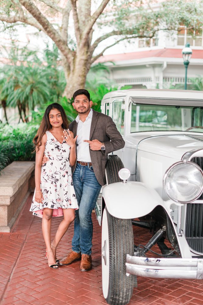 Fun engagement photo with a vintage car at the Grand Floridian Resort in Orlando, Florida