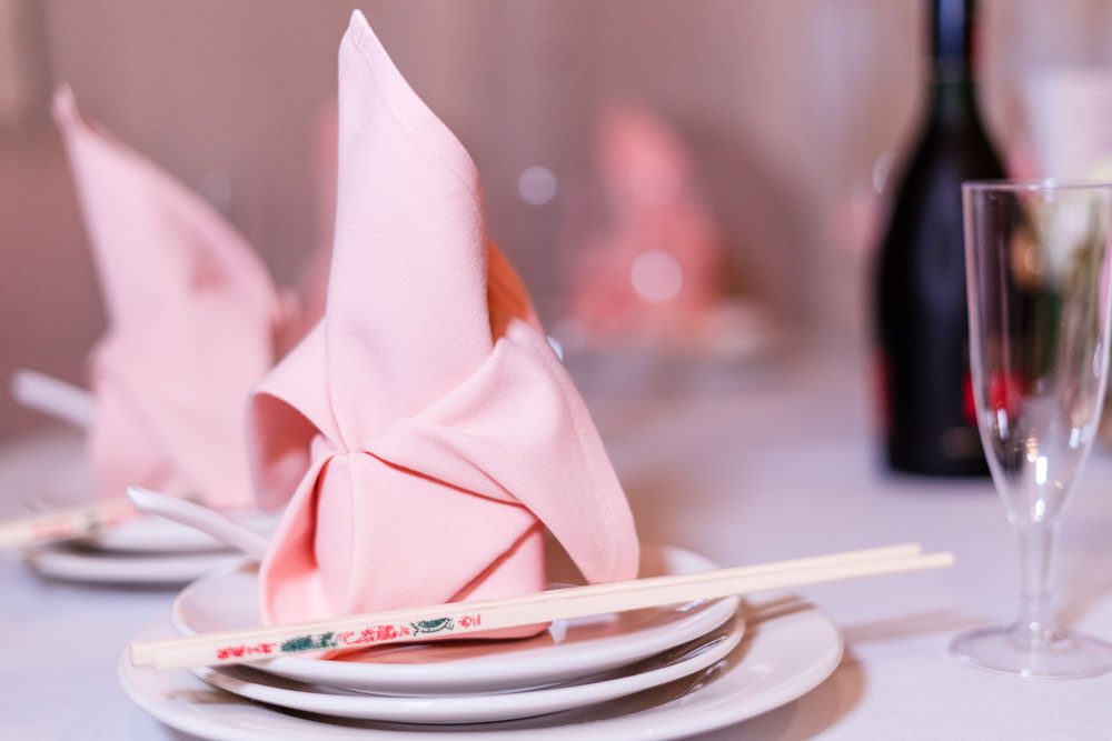 Close up of pink napkin and chop sticks on the reception table at Hy Palace in Oklahoma City