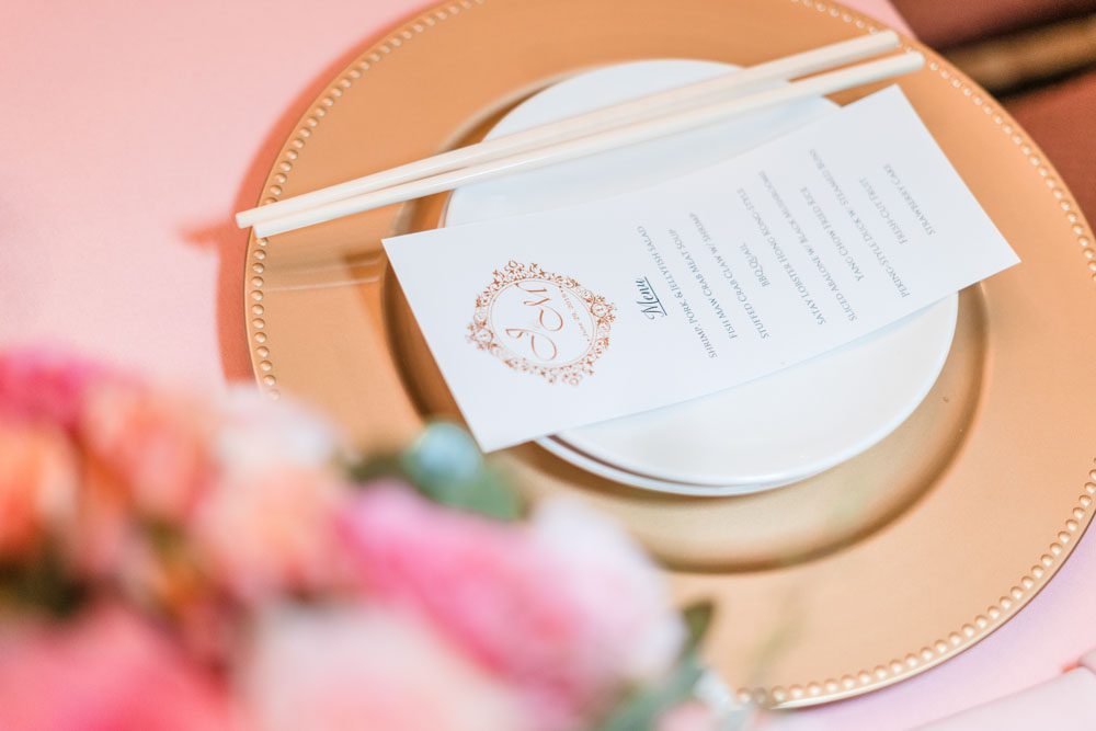 Close up of pink and gold table setting at the reception at Hy Palace in Oklahoma City