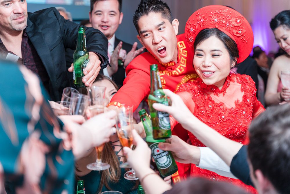 Chinese bride and Vietnamese groom share a toast with their guests at Hy Palace wedding in Oklahoma captured by traveling photographers from Orlando