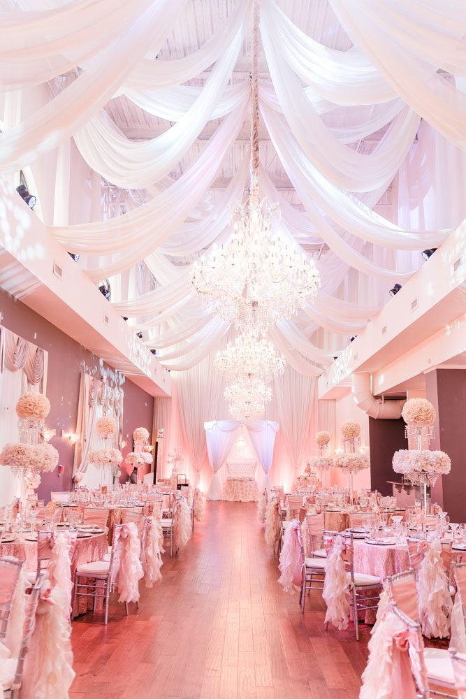 Blush pink, gold and white wedding reception decor at the Crystal Ballroom Veranda captured by top Orlando wedding photographer and videographer