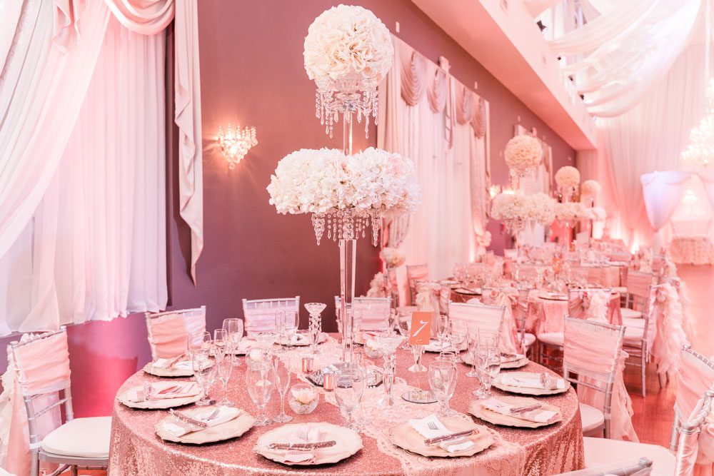 Blush pink, gold and white wedding reception decor at the Crystal Ballroom Veranda captured by top Orlando wedding photographer and videographer