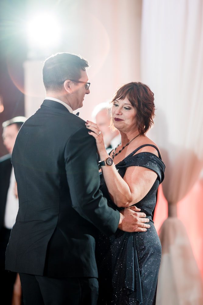 Groom and his mom share their first dance at the Crystal Ballroom Veranda wedding venue in Orlando, Florida