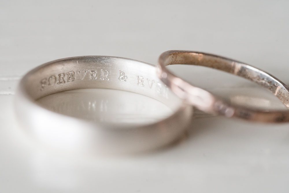 Close up photo of the groom's wedding ring engraving captured by top Orlando wedding photographer and videographer