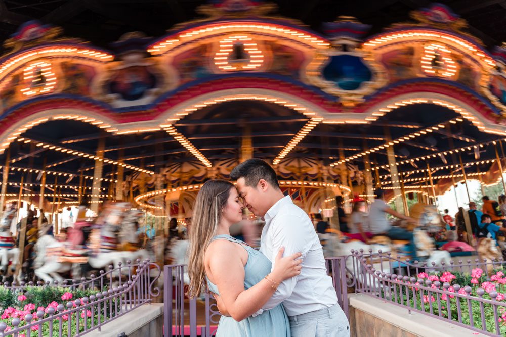 Creative Disney engagement photo at the carousel captured by Orlando photographer