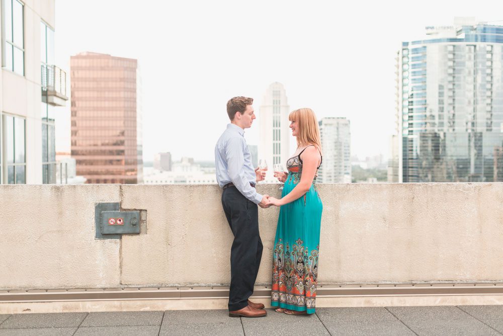 Orlando engagement photographer captures surprise proposal at The Balcony in downtown with skyline views at sunset