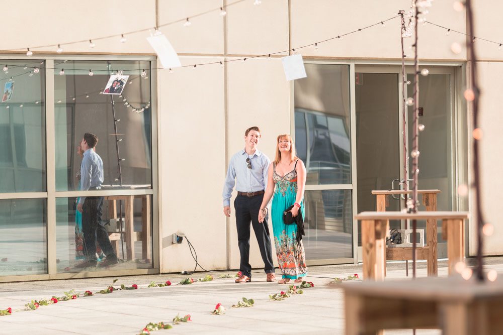 Orlando engagement photographer captures surprise proposal at The Balcony in downtown with skyline views at sunset