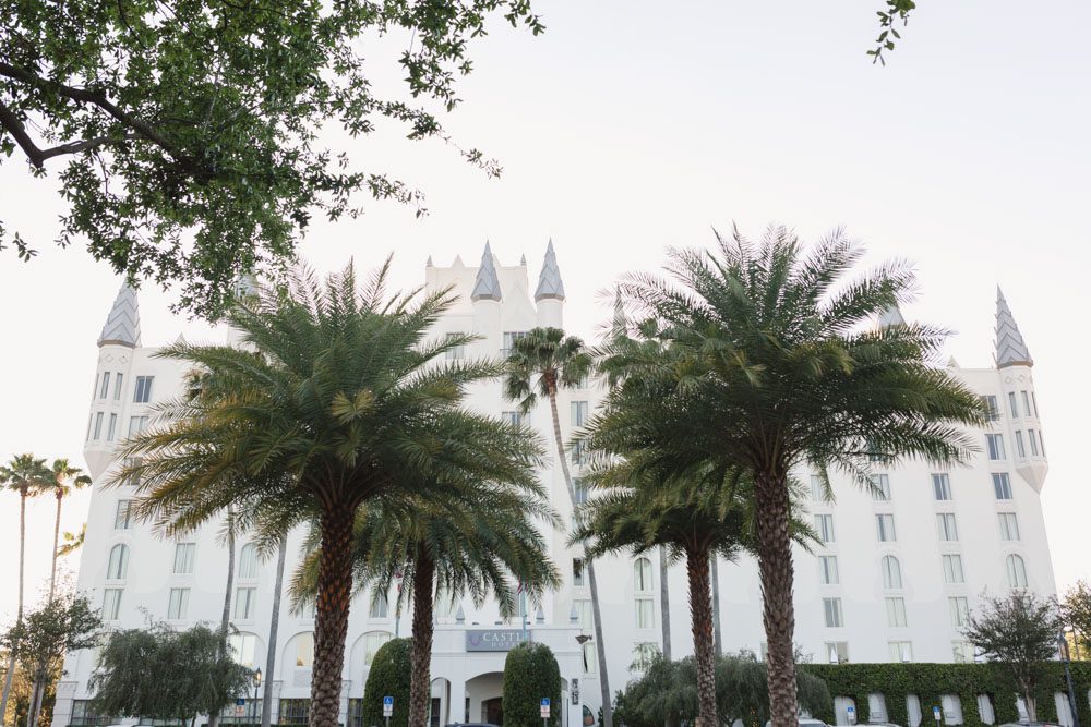 Orlando engagement photographer captures a surprise proposal at The Castle Hotel with sunset views of the ferris wheel