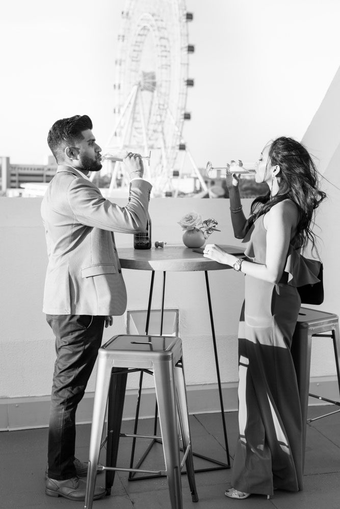 Orlando engagement photographer captures a surprise proposal at The Castle Hotel with sunset views of the ferris wheel