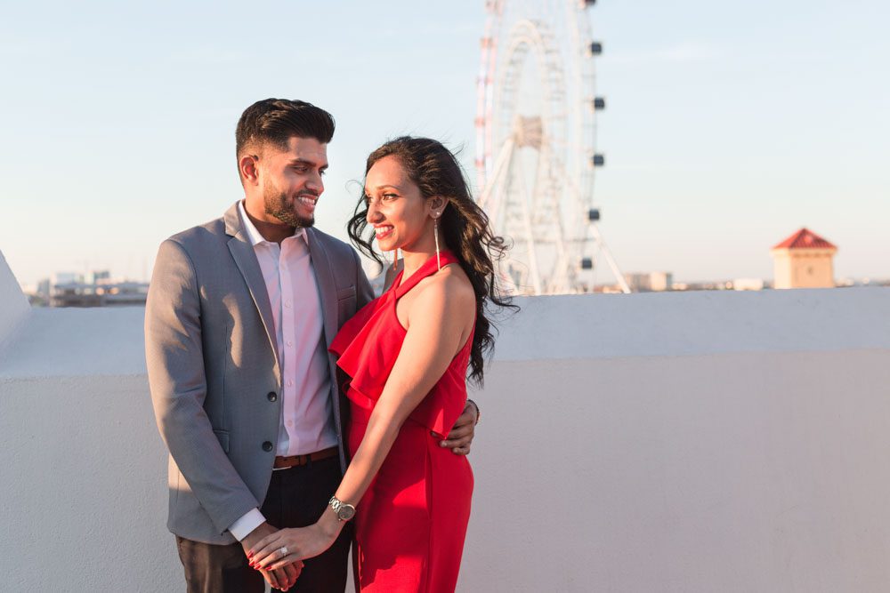 Orlando engagement photographer captures a surprise proposal at The Castle Hotel with sunset views of the ferris wheel