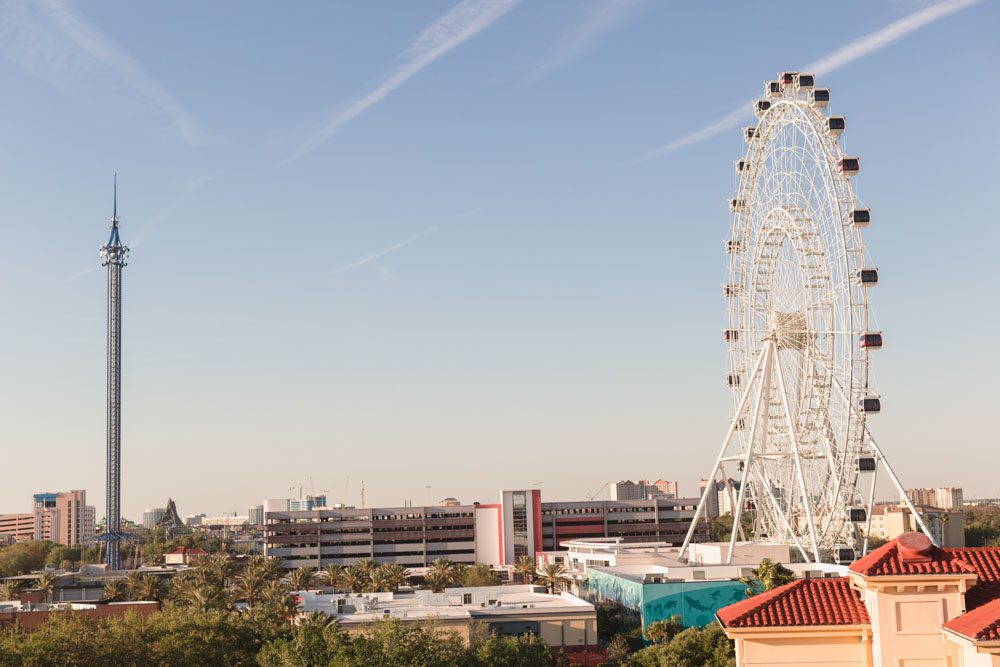 ICON Orlando eye ferris wheel in view during a rooftop proposal captured by top engagement photographer