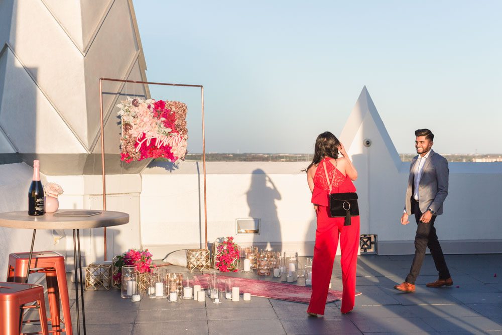 Orlando engagement photographer captures a surprise proposal at The Castle Hotel with sunset views of the ferris wheel